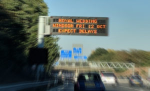 Overhead traffic sign warning of delays due to royal wedding