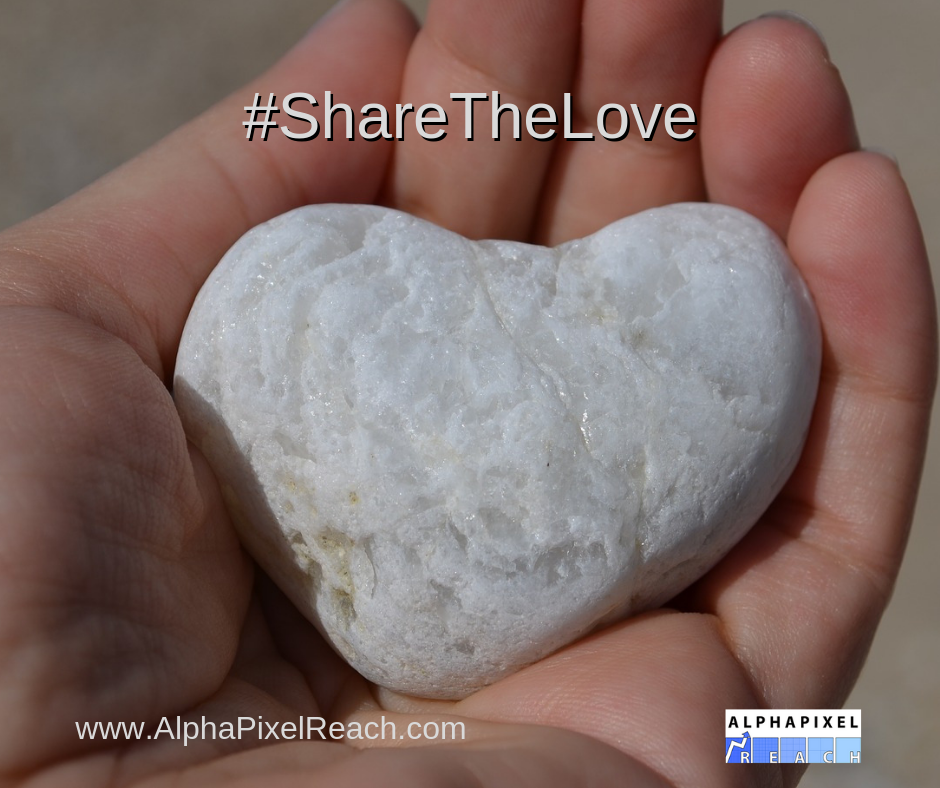 #ShareTheLove hand holing heart shaped stone